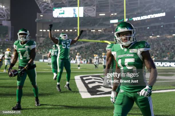 Shawn Bane Jr. #15, Tevin Jones and Eric Lofton of the Saskatchewan Roughriders celebrate a touchdown in the game between the Edmonton Elks and...