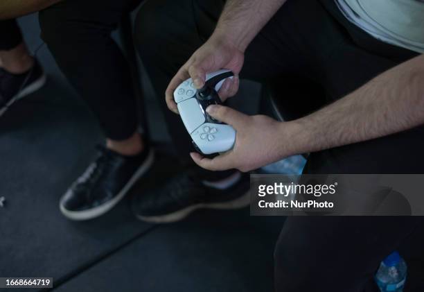 An Iranian gamer using a SONY PS5 controller during Iran's FIFA 23 Esports competitions, in Tehran, September 15, 2023.