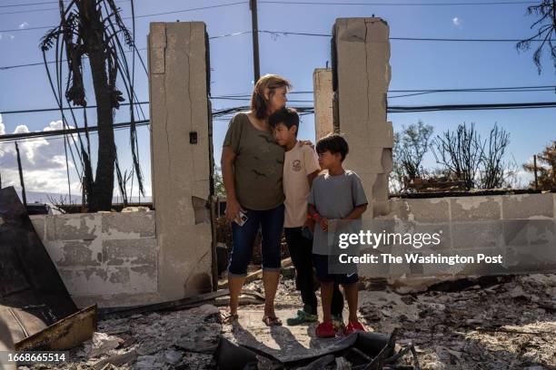 Val Casco and her grandsons Hawea Casco and Hanuola Casco stand at the entrance to her home, which was destroyed in the Aug. 8 wildfires in Lahaina,...