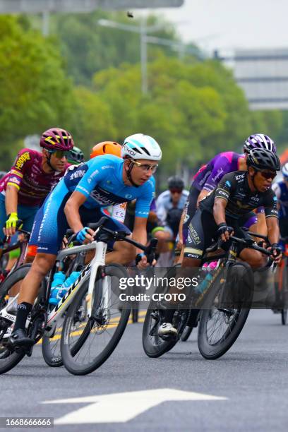 Cyclists celebrate with champagne on the podium during the 2023 11th Round Taihu International Road Cycling Race in Dianshanhu town, Kunshan city,...