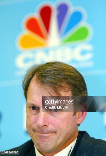 Alexander Brown, president and chief executive of CNBC Asia Pacific fields a journalist's question at a press conference before they sign a...