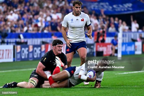 Scott Barrett of New Zealand tackles Gael Fickou of France during the Rugby World Cup France 2023 match between France and New Zealand at Stade de...