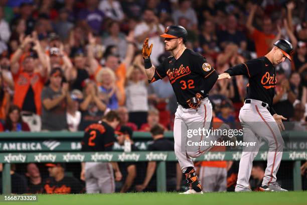 Ryan O'Hearn of the Baltimore Orioles celebrates with third base coach Tony Mansolino after hitting a solo home run against the Boston Red Sox during...