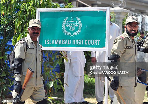 Pakistani paramilitary soldiers exit the high court after the case hearing of former military ruler Pervez Musharraf in Islamabad on April 18,2013. A...