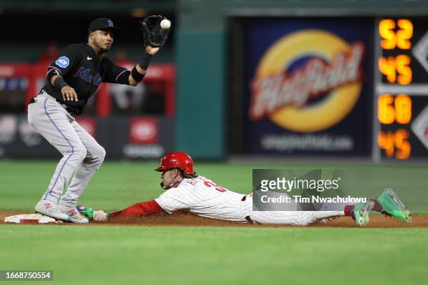 Bryce Harper of the Philadelphia Phillies steals second base past Luis Arraez of the Miami Marlins during the third inning at Citizens Bank Park on...