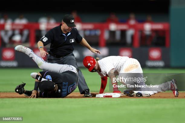 Bryson Stott of the Philadelphia Phillies steals second base past Luis Arraez of the Miami Marlins during the third inning at Citizens Bank Park on...