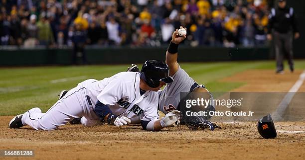 Justin Smoak of the Seattle Mariners is tagged out at home for the final out as catcher Brayan Pena of the Detroit Tigers displays the ball to the...