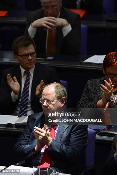 Peer Steinbrueck, chancellor candidate of the German Social Democrats applauds at the end of Finance Minister Wolfgang Schaeuble's speech at the...