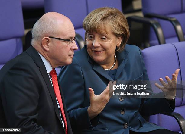 German Chancellor Angela Merkel chats with Volker Kauder, Chairman of the CDU/CSU parliamentary group in the Bundestag, prior to debates over EU...