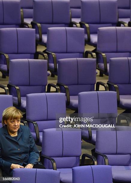 German Chancellor Angela Merkel attends a debate at the German parliament prior to vote on a bailout package for debt-mired Cyprus, with approval...