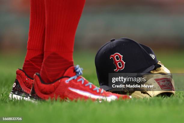View of the baseball hat and glove of Trevor Story of the Boston Red Sox during the fifth inning against the Baltimore Orioles at Fenway Park on...