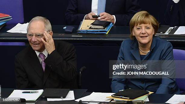 German Chancellor Angela Merkel and German Finance Minister Wolfgang Schaeuble react after the result of the a bailout package for debt-mired Cyprus...