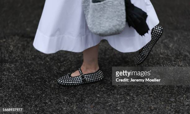 Guest, shoe detail, seen outside Collina Strada show wearing silver necklace, white maxi dress, silver handbag and silver studed Alaia ballet flats...