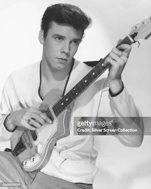 English rock 'n' roll singer Marty Wilde posing with an electric guitar, circa 1960.
