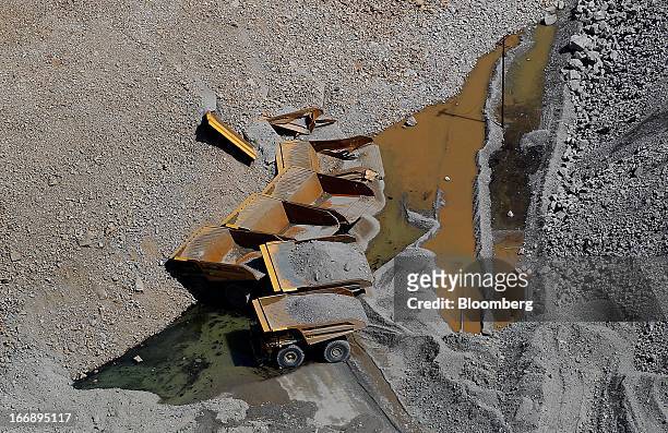 Bloomberg Photo Service 'Best of the Week': Dump trucks buried by the Bingham Canyon copper mine wall slide are seen in this aerial photograph taken...