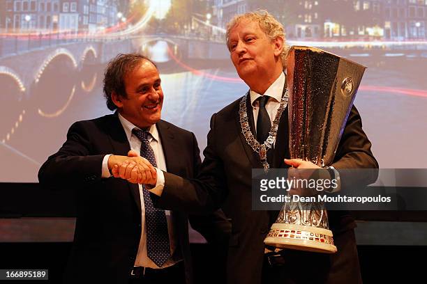 Michel Platini , President of the Union of European Football Associations hands over the trophy to Eberhard E. Van der Laan, Mayor of Amsterdam in...