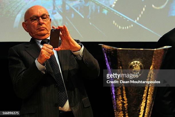 Michael van Praag, KNVB President takes a photo of the Trophy on his mobile phone during the UEFA Europa League trophy handover ceremony at Beurs van...