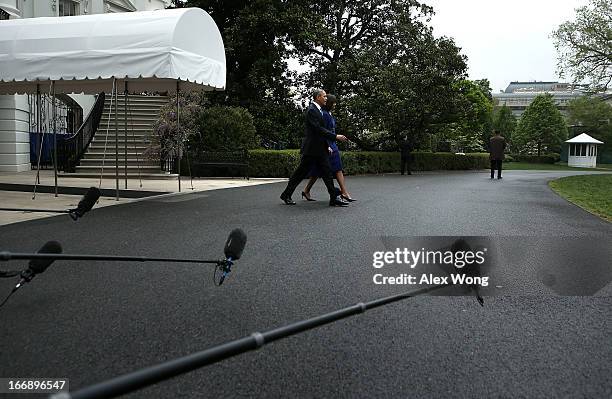 President Barack Obama and first lady Michelle Obama come out from the White House prior to their departure for Boston, on April 18, 2013 in...