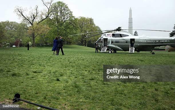 President Barack Obama and first lady Michelle Obama walk toward the Marine One prior to their departure for Boston April 18, 2013 in Washington, DC....