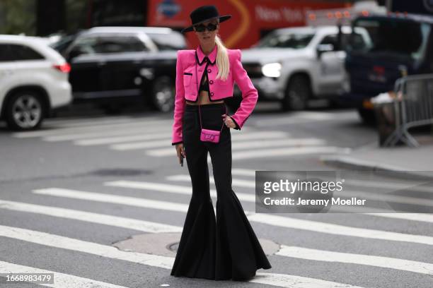 Denisa Palsha is seen outside Christian Siriano wearing black hat, hot pink cropped and buttoned up Sergio Hudson jacket, pink mini Valentino...