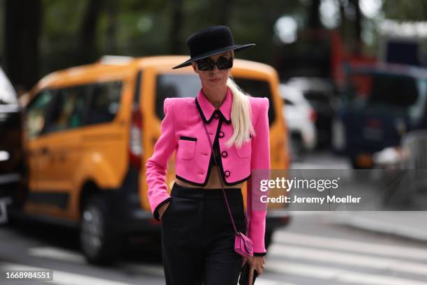 Denisa Palsha is seen outside Christian Siriano wearing black hat, hot pink cropped and buttoned up Sergio Hudson jacket, pink mini Valentino...