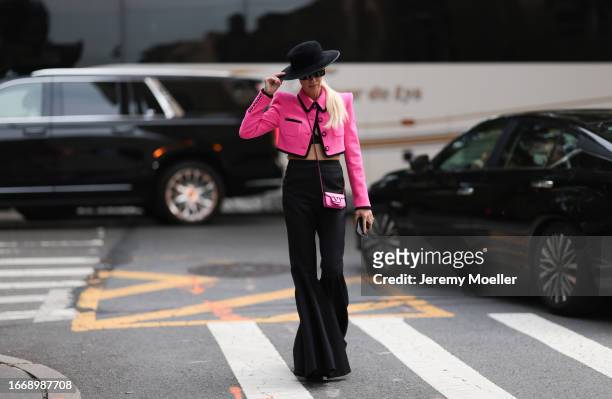 Denisa Palsha is seen outside Christian Siriano wearing black hat, hot pink cropped and buttoned up Sergio Hudson jacket, pink mini Valentino...