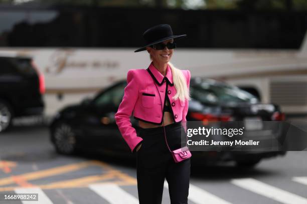 Denisa Palsha is seen outside Christian Siriano wearing black hat, hot pink cropped and buttoned up Sergio Hudson jacket, pink mini Valentino...