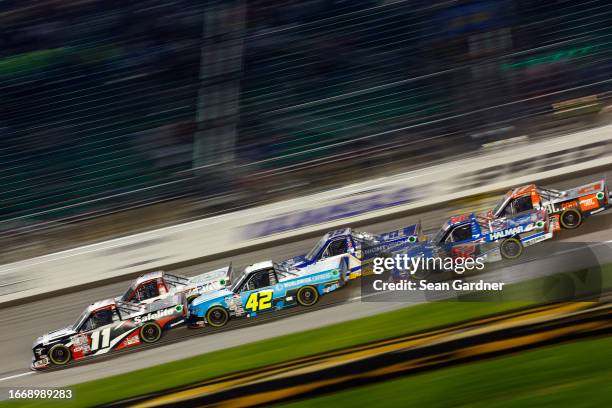 Corey Heim, driver of the Safelite Toyota, Carson Hocevar, driver of the Worldwide Express Chevrolet, and Stewart Friesen, driver of the Halmar...