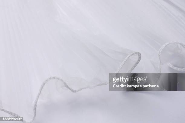 white lightweight fabric mesh, texture of the fabric, beautifully draped background. - lit satin stock-fotos und bilder