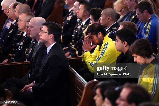 Runners pray at an interfaith prayer service for victims of the Boston Marathon attack titled "Healing Our City," and attended by President Barack...