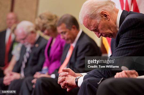Vice President Joe Biden bows his head in prayer during an event in the Capitol Visitor Center, to dedicate the Gabe Zimmerman Meeting Room, a...