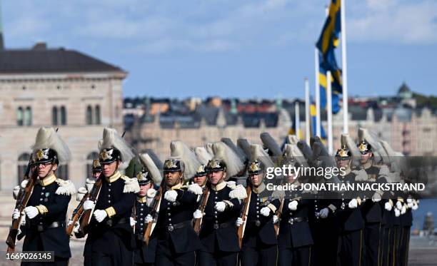 Royal guards parade during festivities to celebrate the 50th anniversary of Sweden's King Carl XVI Gustaf's accession to the throne at the Royal...