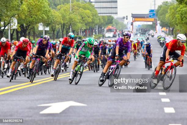 Cyclists celebrate with champagne on the podium during the 2023 11th Round Taihu International Road Cycling Race in Dianshanhu town, Kunshan city,...