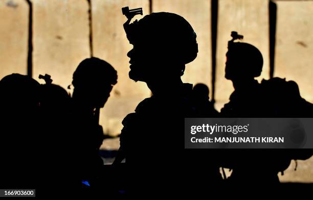 Army soldiers wait for orders at the Forward Base Honaker Miracle at Watahpur District in Kunar province prior to a joint patrol led by the Afghan...