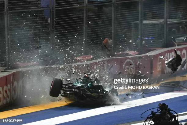 Aston Martin's Canadian driver Lance Stroll crashes during the qualifying session of the Singapore Formula One Grand Prix night race at the Marina...