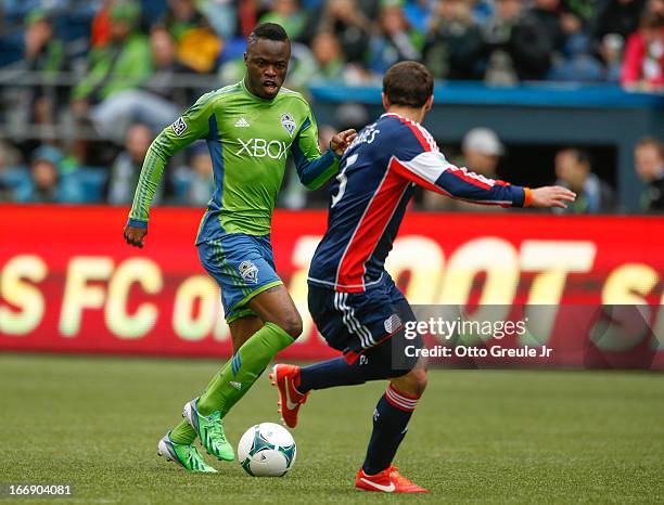 Steve Zakuani of the Seattle Sounders FC dribbles against A.J. Soares of the New England Revolution at CenturyLink Field on April 13, 2013 in...