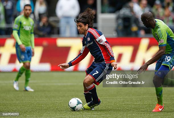 Juan Toja of the New England Revolution dribbles against the Seattle Sounders FC at CenturyLink Field on April 13, 2013 in Seattle, Washington.