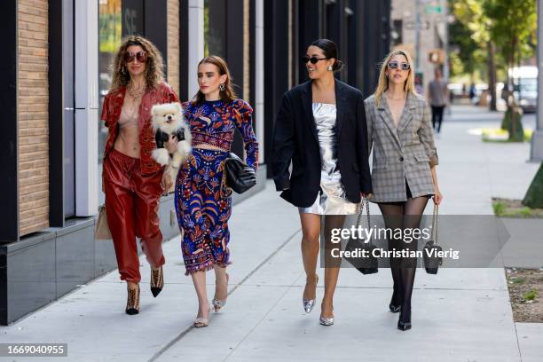 Vanessa Calderon wears red shirt, pants & Urszula Makowska with Mochi the Pomeranian dog wears top & skirt Farm Rio, black bag Saint Laurent,...