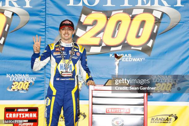 Christian Eckes, driver of the PEAK/NAPA Nightvision Chevrolet, celebrates in victory lane after winning the NASCAR Craftsman Truck Series Kansas...