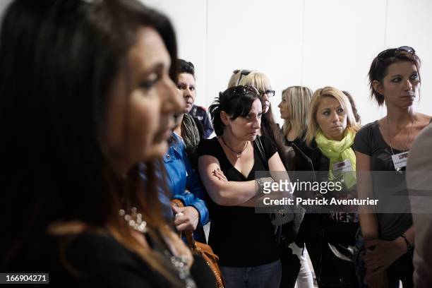 Women who received PIP breast implants speak with plaintiff lawyer Laurent Gaudon outside a courtroom on April 18, 2013 at the courthouse at Parc...