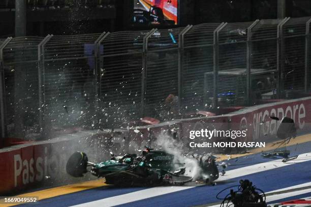 Aston Martin's Canadian driver Lance Stroll crashes during the qualifying session of the Singapore Formula One Grand Prix night race at the Marina...