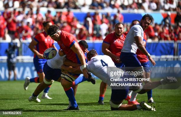 Chile's openside flanker Clemente Saavedra is tackled by Samoa's lock Chris Vui during the France 2023 Rugby World Cup Pool D match between Samoa and...