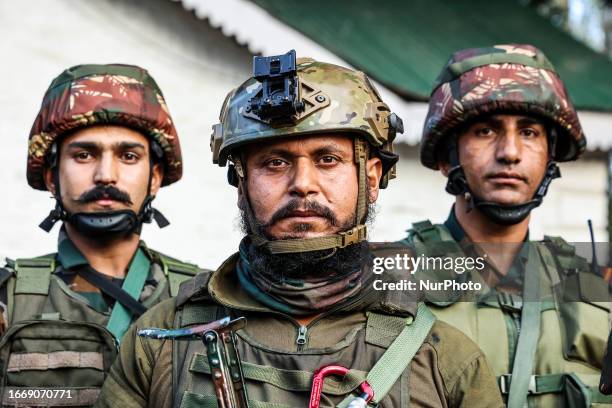 Indian army soldiers display weapons and Cash recovered from Militants who were killed during an Encounter At Hathlanga In Uri Baramulla Jammu and...