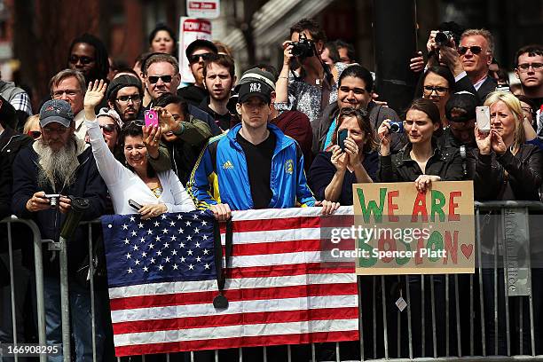 People wait for President Barack Obama's motorcade after he spoke at an interfaith prayer service for victims of the Boston Marathon attack titled...