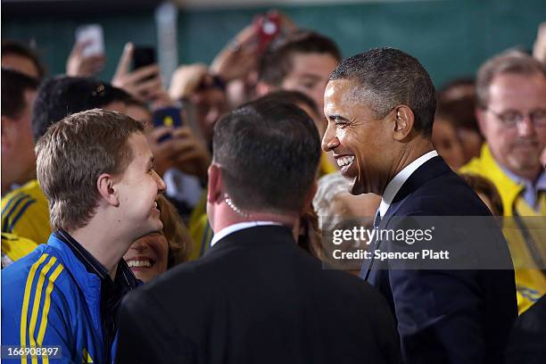 President Barack Obama speaks to runners and Boston Marathon volunteers at Cathedral High School after attending an interfaith prayer service for...