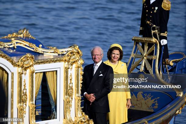 King Carl XVI Gustaf of Sweden and Queen Silvia of Sweden stand on a royal boat during festivities to celebrate the 50th anniversary of Sweden's King...