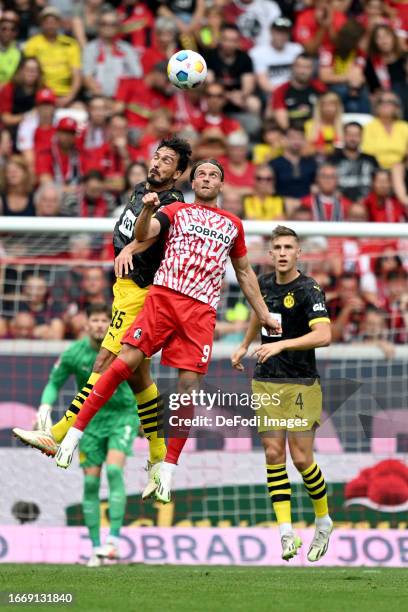 Mats Hummels of Borussia Dortmund and Lucas Hoeler of SC Freiburg battle for the ball during the Bundesliga match between Sport-Club Freiburg and...