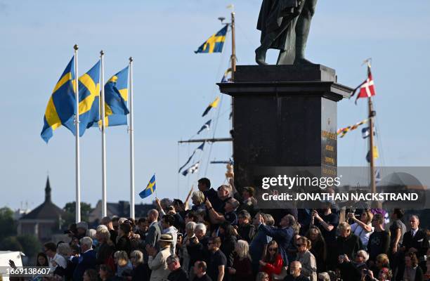 Spectators crowd to watch Sweden's King and Queen during festivities to celebrate the 50th anniversary of Sweden's King Carl XVI Gustaf's accession...
