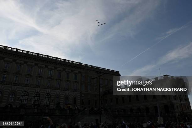 Jet fighters fly in formation above the Royal Palace during festivities to celebrate the 50th anniversary of Sweden's King Carl XVI Gustaf's...