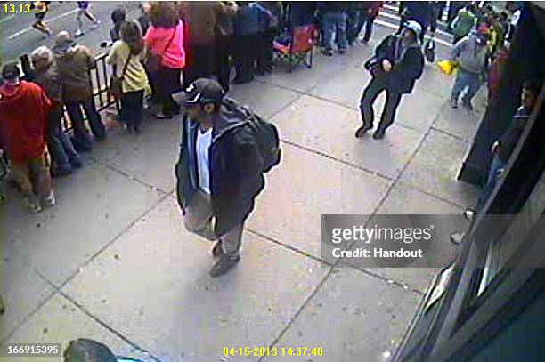 In this image released by the Federal Bureau of Investigation on April 18 two suspects in the Boston Marathon bombing walk near the marathon finish...